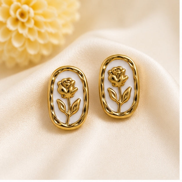Vintage gold-tone oval stud earrings with embossed rose floral design and white enamel for women by Glanz Jewels.