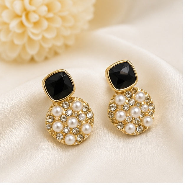 Luxury gold-plated black stone pearl drop earrings with crystal embellishments for women by Glanz Jewels.