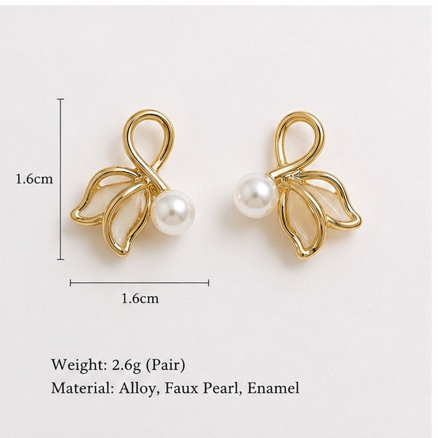 Elegant gold tone pearl leaf stud earrings for women with faux pearl and enamel detailing by Glanz Jewels.